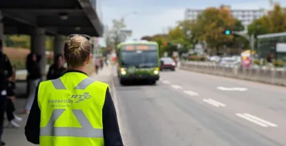 Une inspectrice se tient à un arrêt d'autobus